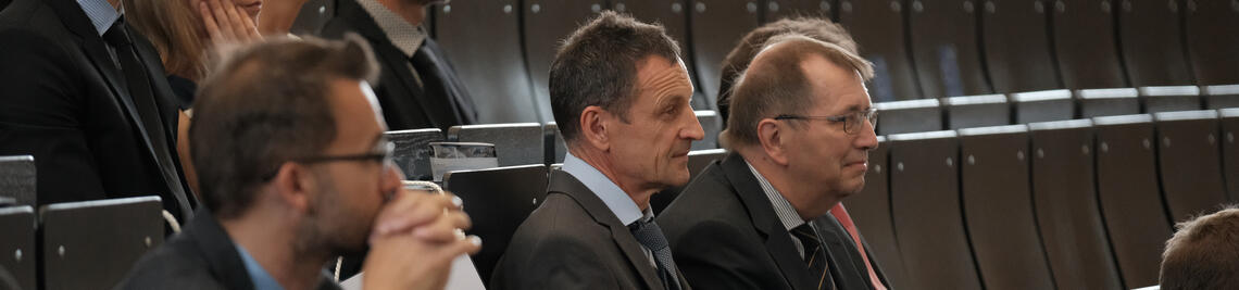 Dean and President sitting in the audience of the lecture hall